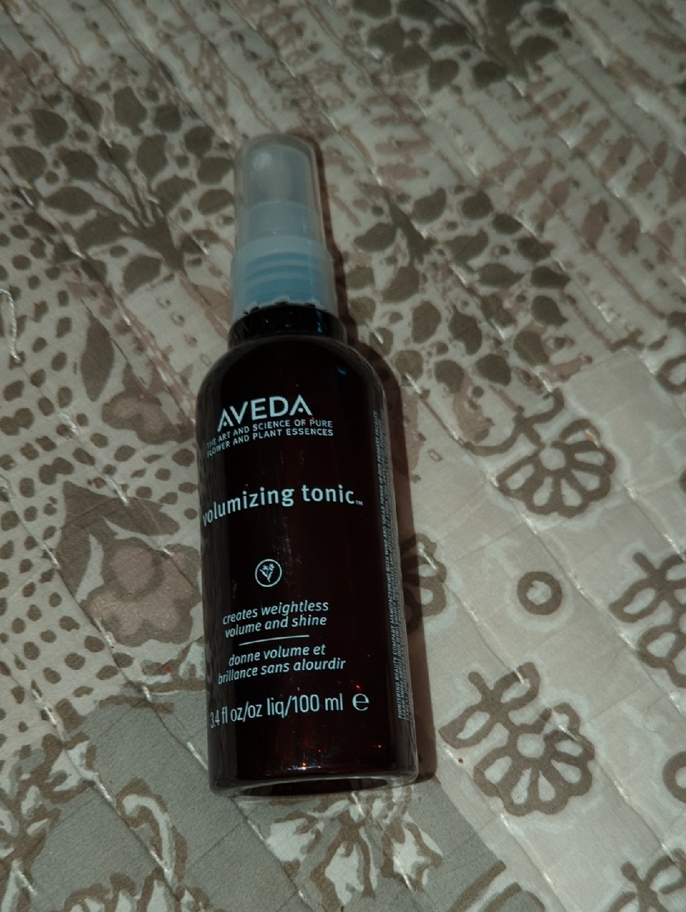 AVEDA Volumizing Tonic - Dark Brown Bottle with Light Blue Text
